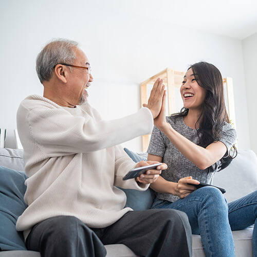 grandfather and granddaughter high-fiving